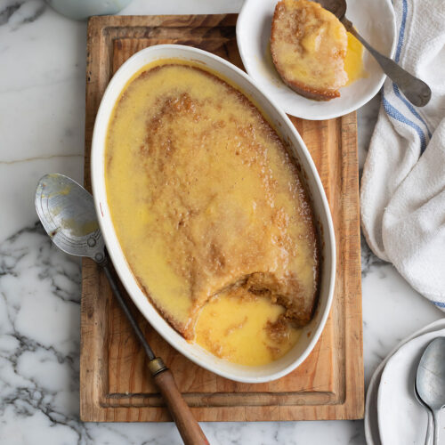 Orange Malva Pudding: The Best Malva Pudding Recipe • Drizzle and Dip Orange Malva Pudding Recipe in a dish on a board
