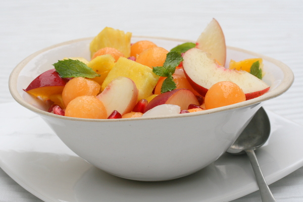 summer fruit salad with a ginger, mint and lime dressing