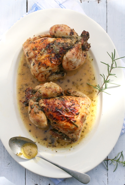 Roasted baby chickens in wine and herbs