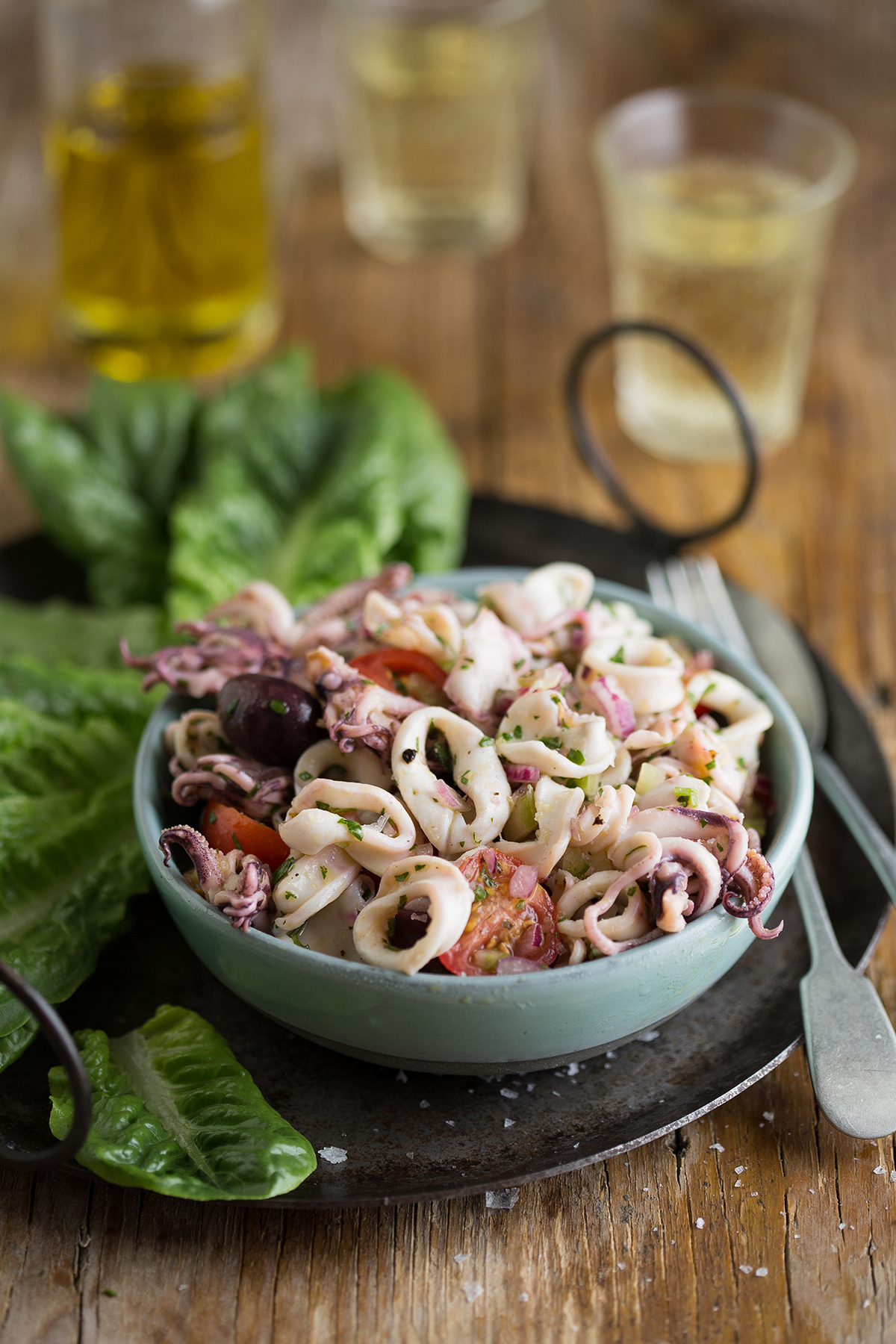 A delicious calamari salad with tomatoes, olives & lemon