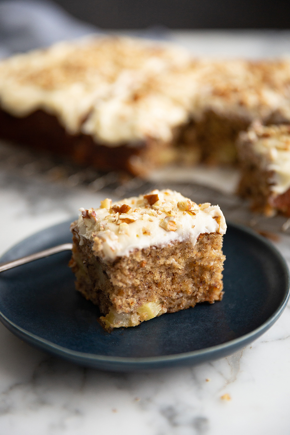 A slice of hummingbird sheet cake with cream cheese frosting