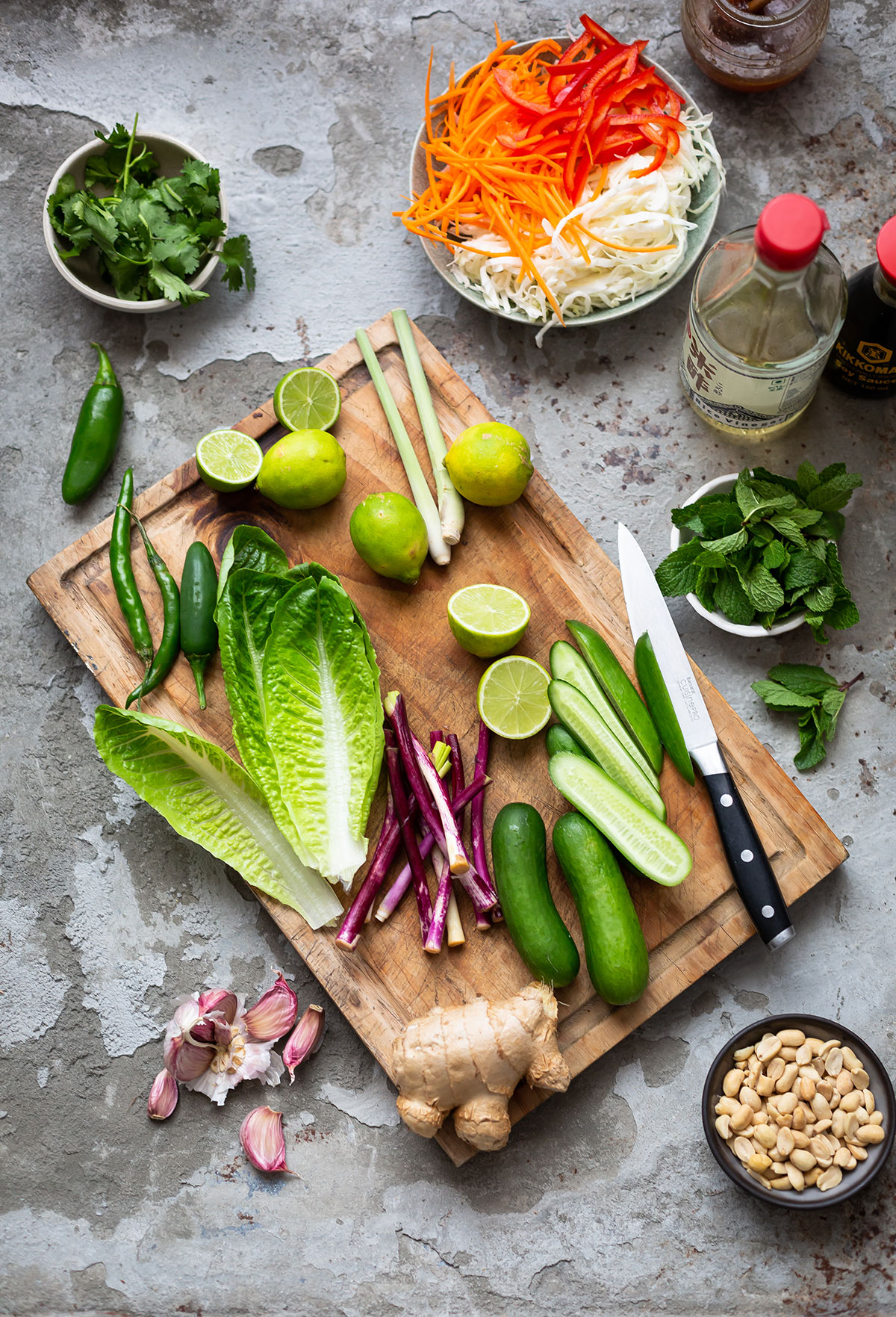Fresh ingredients for a Vietnamese rice noodle salad with grilled chicken recipe laid out on a board.