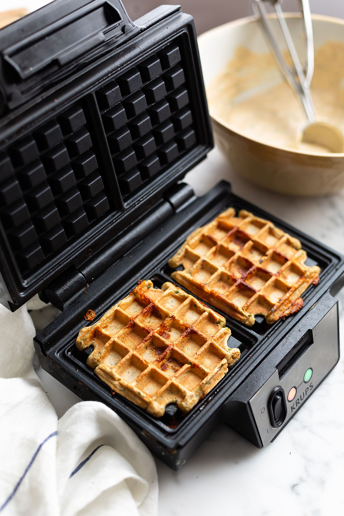 Easy & Healthy high protein cottage cheese waffles in a waffle maker with chives and mozarella 