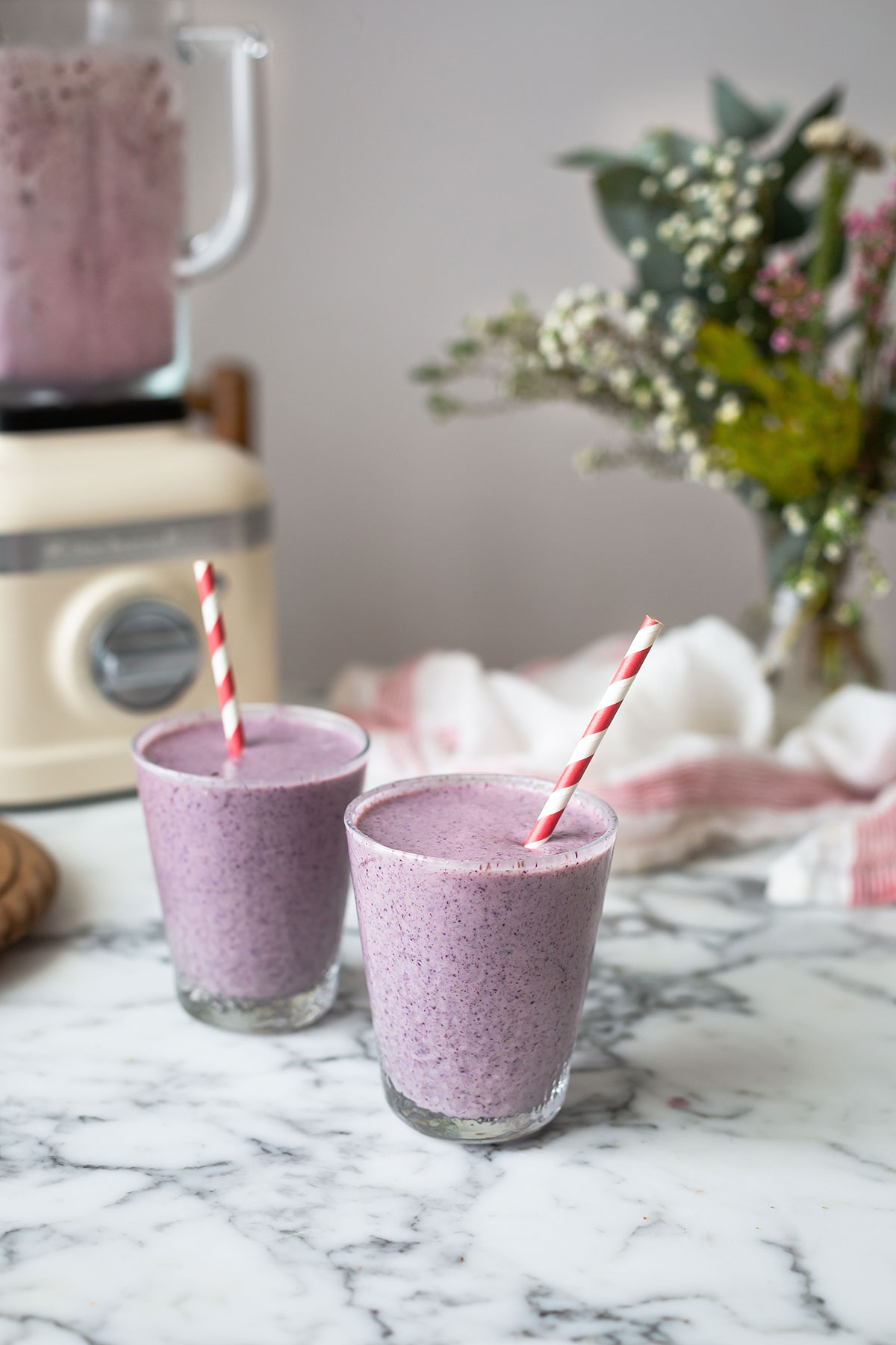 Two healthy blueberry & banana protein smoothies