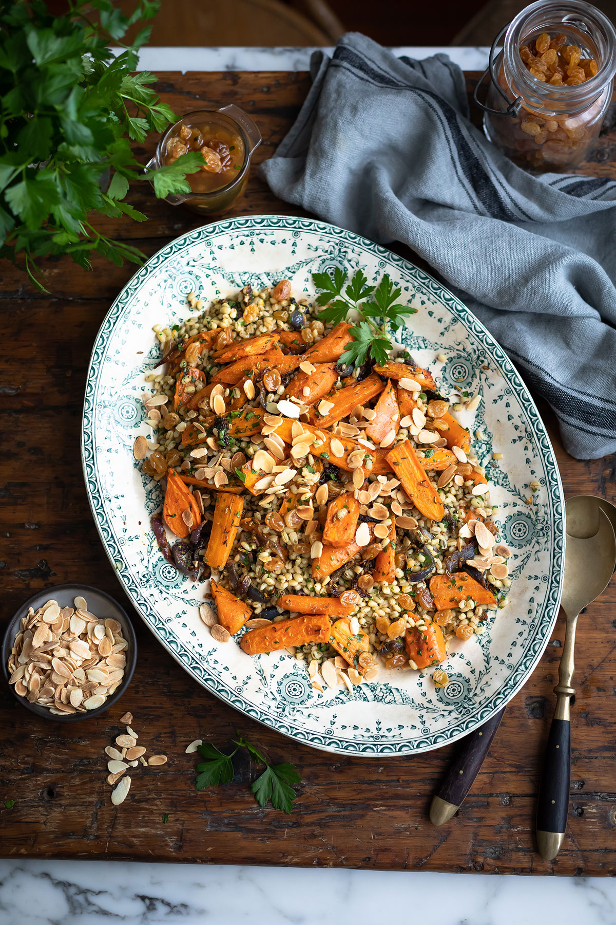 A large platter with roast carrot and barley salad with pickled sultanas