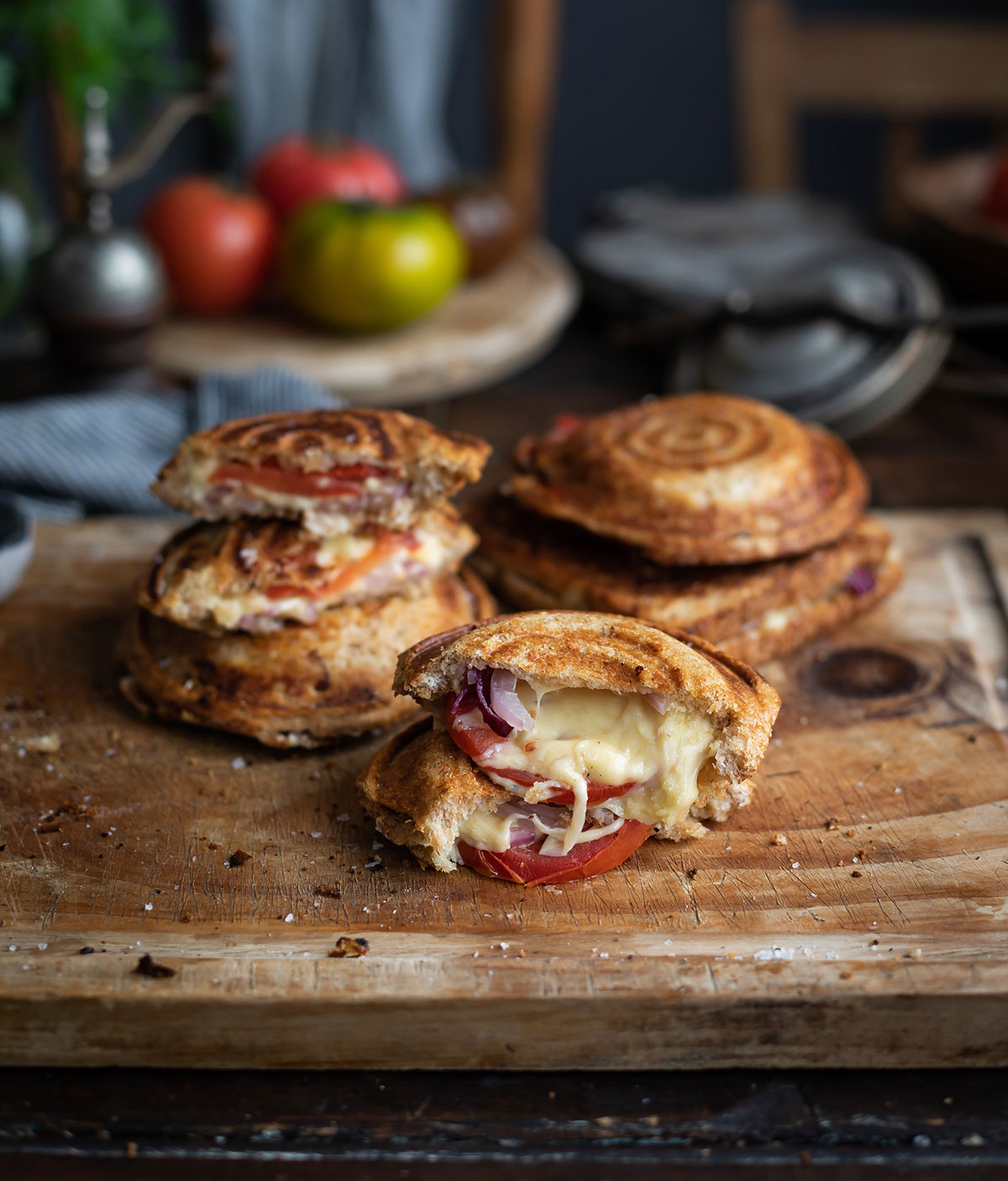 A board with classic South African Braaibroodjie jaffles (grilled cheese sandwich with tomato and onion)