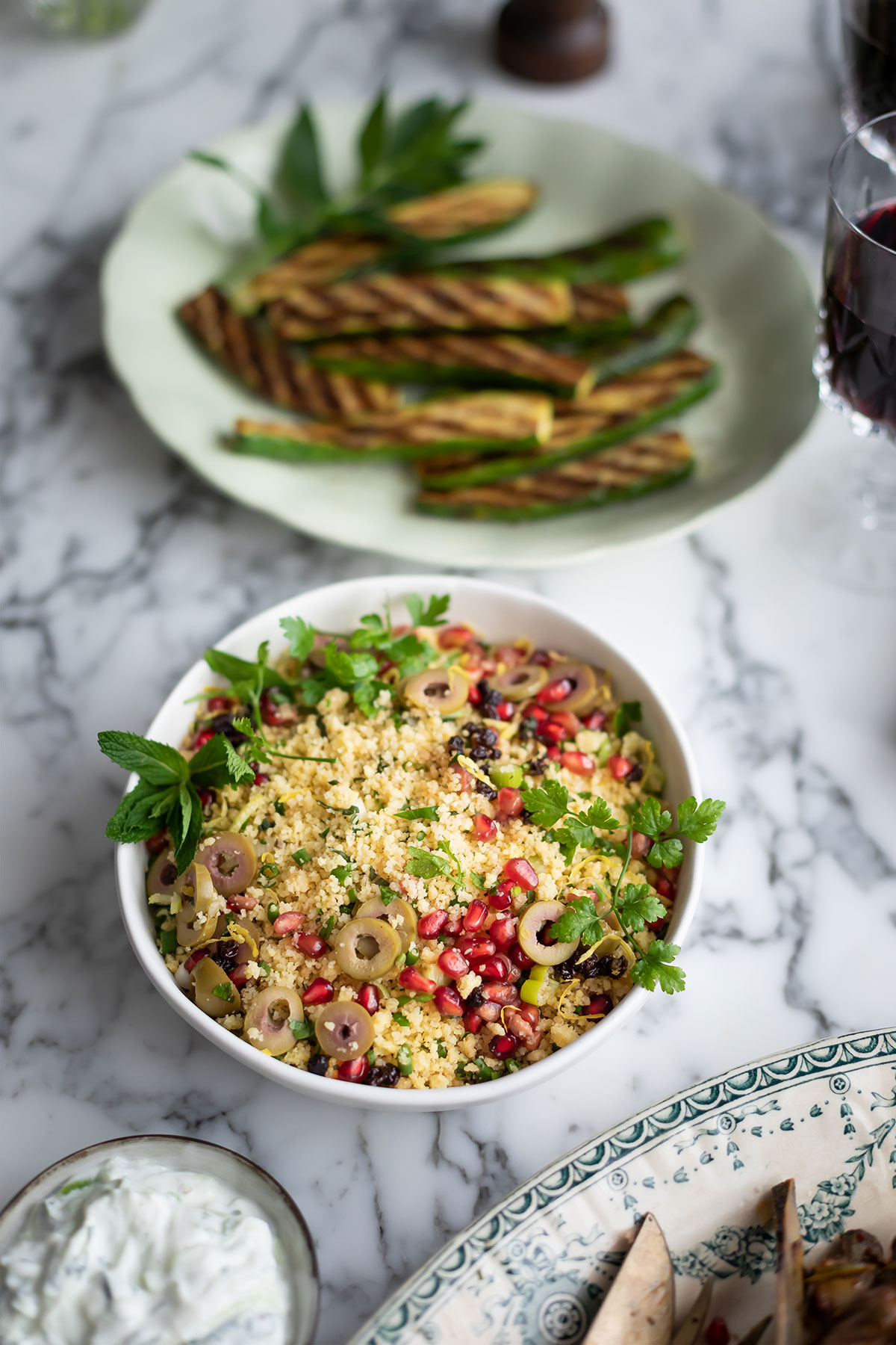 A bowl of herby cous cous for slow-roasted shoulder of lamb with harissa & garlic recipe