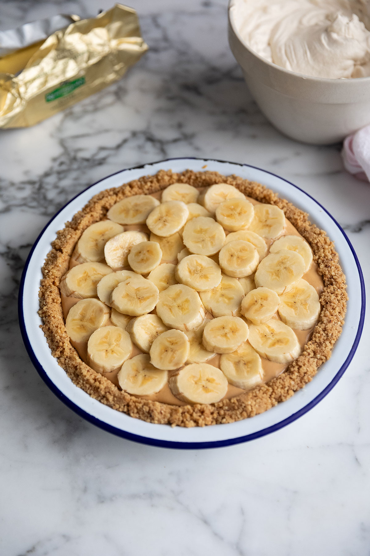 A banoffee pie with pecans before the whipped cream topping