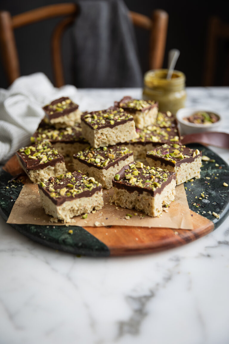 squares of Dubai Chocolate Rice Krispie treats with Pistachio on a board